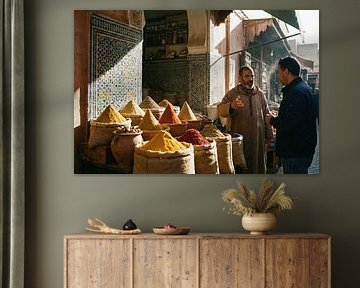 Spice merchant communicating to customer in marrakesh souk by Markus Gann