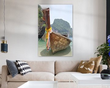 A traditional Thai wooden boat floats on the calm waters of a sandy beach in a tropical Thai bay, with lush green mountains in the background. by UMA Digital NL