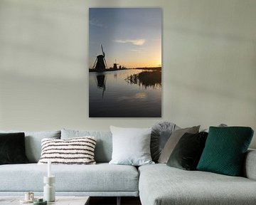 A beautiful, typical Dutch landscape with windmills on a calm body of water at sunrise in Kinderdijk. by UMA Digital NL