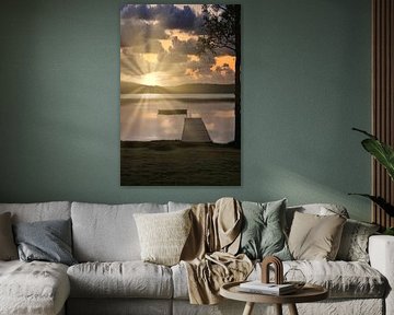 A wooden jetty on the lake in the morning mist, flooded with sunlight and a calm reflection. by Martin Köbsch