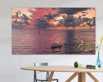 Vissersboot bij Zonsondergang tussen Windmolens op Zee van Ewold Kooistra