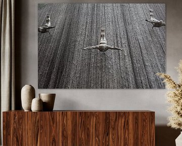 Three figures on concrete wall by Arthur van Iterson