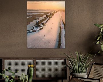 Ice skating at Kinderdijk in Golden Light by Ewold Kooistra