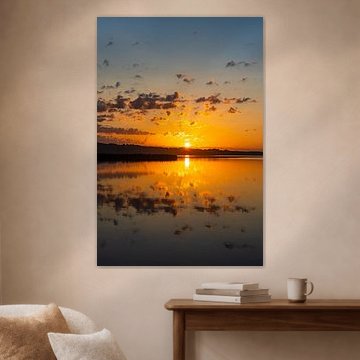 Sunrise in Seedorf on Lake Schaal, with clouds and a reflection