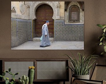 man walks in front of mosque by Antwan Janssen