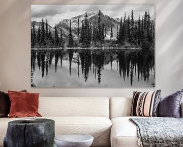 Black/white reflection of mountain and trees in Canadian lake by Milou Mouchart
