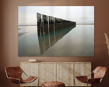Row of breakwaters in the sea in Holland by Anouk Noordhuizen