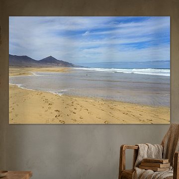 Waves reaching far out onto the beach along the shallow coastline of Playa de Cofete by Tomherkules