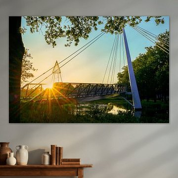 De Slinger cycle bridge in Drachten, featuring a sunburst and flare