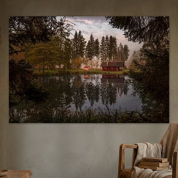 Rood houten huis aan een rustig meer van Harald Bader Photography