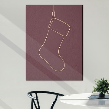 Élégante chaussette de Noël dorée sur fond rose poudré