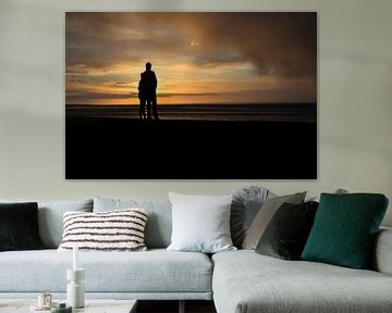 Romantic young couple at sunset on the Wadden Sea by Tim Groeneveld