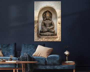 Buddha statue in a niche of a white wall of a temple in Nepal by Rietje Bulthuis