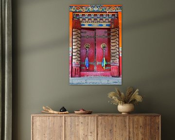 Red door with prayer flags in a Tibetan monastery by Rietje Bulthuis