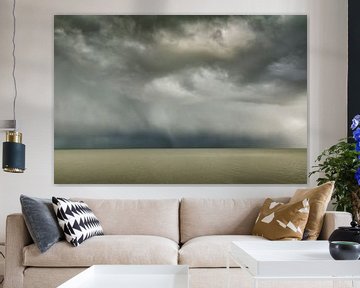 Donkere hagelwolken boven een kalme waddenzee van Marjon Meinders