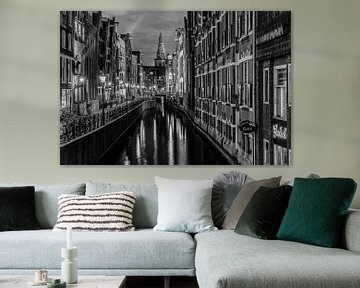 Amsterdam Damrak canal at night in Black and White by Mario Calma
