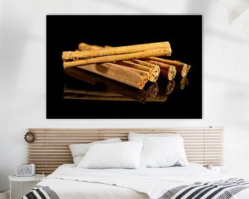 Cinnamon sticks isolated on a black background with reflection