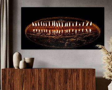 Burning butter candles in a dark temple in Tibet by Rietje Bulthuis