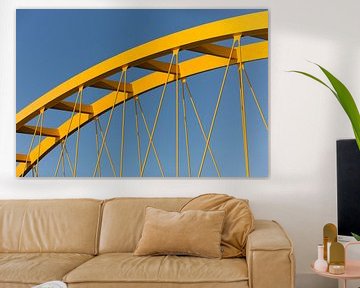 Gele stalen brug in Utrecht tegen een blauwe lucht van mike van schoonderwalt