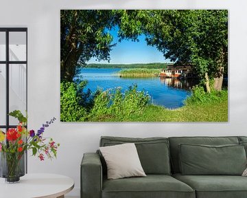 Landscape on a lake with boatshouse van Rico Ködder