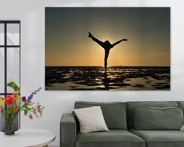 Artistic nude in the Wadden Sea on one leg in a pose propeller by Arjan Groot