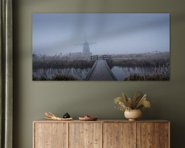 Windmill in Kinderdijk in the mist by Toon van den Einde