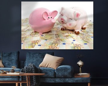 Twee spaarvarkensTwo pink piggy banks on spread euro notes van Ben Schonewille