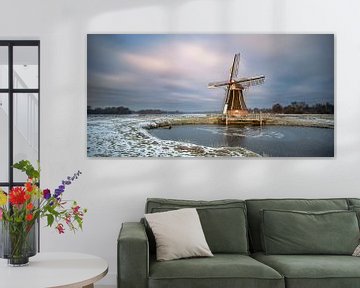 Dutch windmill at a lakeside by Peter Bolman