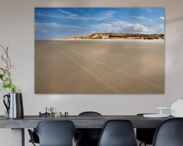 Beach scene with sand dunes in the background.