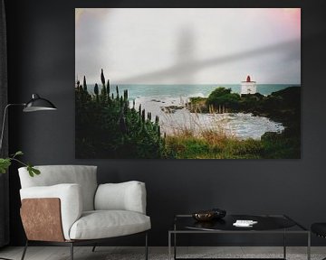 Analog photograph of a New Zealand coastline, featuring a red and white lighthouse