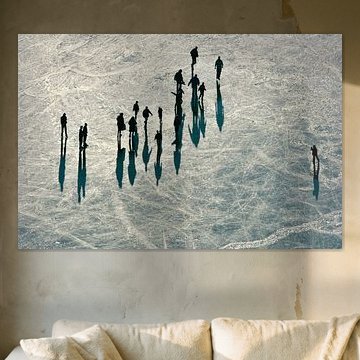 Aerial shot of winter landscape, a group of people skating on the Vinkeveen lakes