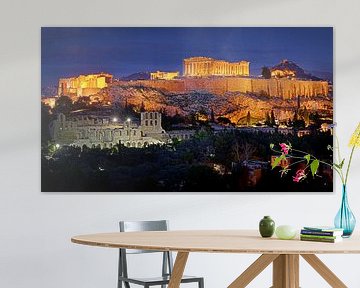 The acropolis of Athens in Greece lit by artificial light against a twilight deep blue sky