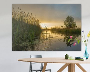 Landschap, zonsopkomst bij molen met weerspiegeling in het water van Marcel Kerdijk