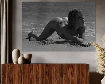 Sensual nude model on the beach with water drops on the buttocks by Arjan Groot