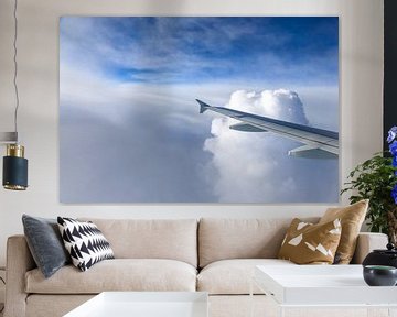 Airplane wing in the clouds by Inge van den Brande