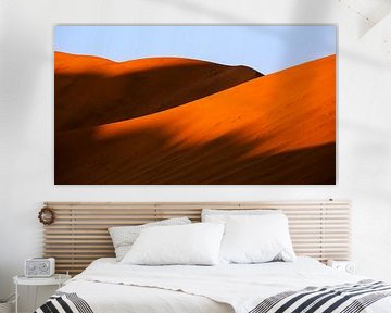 Shade on red sand dunes in Sossusvlei, Namibia by Martijn Smeets