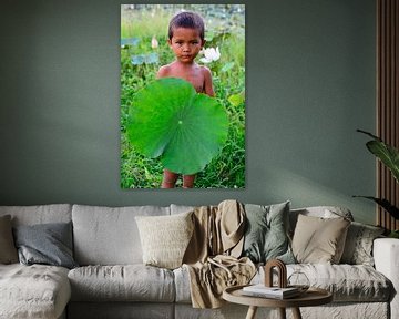 Boy with Lotus flower leaf in Cambodia.