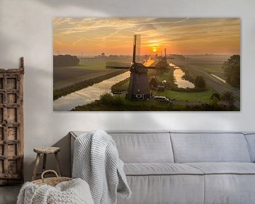 Typical Dutch windmill during sunrise