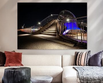 Futuristische verlichte publieke werken met trappen, voetgangerspad en train viaduct van Fotografiecor .nl
