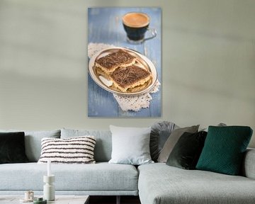 Home-baked chocolate caramel cuts lie in a metal bowl on a blue wooden table