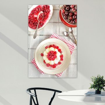 Ein Pudding mit frisch gekochtem Kirschkompott steht auf einem Teller