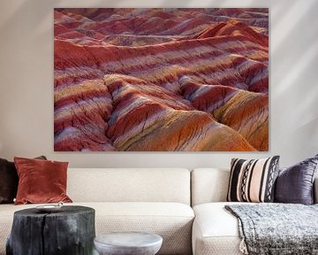 Landscape with red erosion hills at sunrise by Chris Stenger