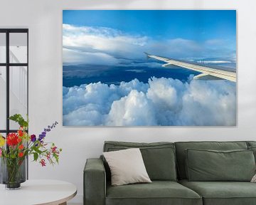Clouds and airplane wing by Inge van den Brande