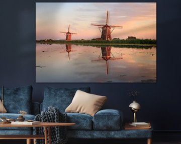 Reflection of two traditional windmills in the water at sunset by iPics Photography