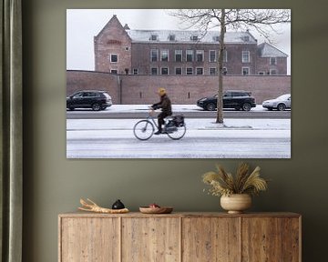 Castle Woerden with cyclist in the foreground in the snow.