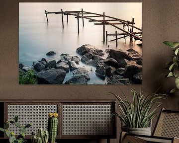 Old broken jetty in the river Lek in The Netherlands