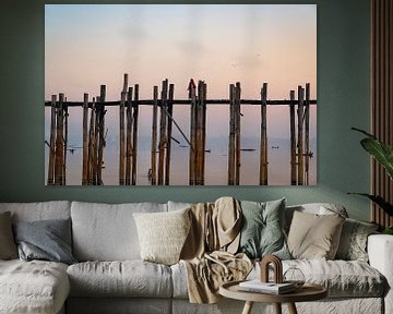 Monk walks over wooden U-Bein bridge at Mandalay in Myanmar. by Twan Bankers