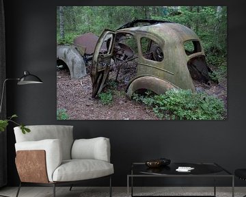 Car cemetery in forest in Ryd, Sweden by Joost Adriaanse