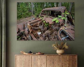 Car cemetery in forest in Ryd, Sweden by Joost Adriaanse