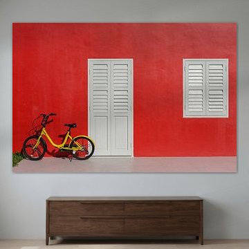 Red wall with yellow children's bike